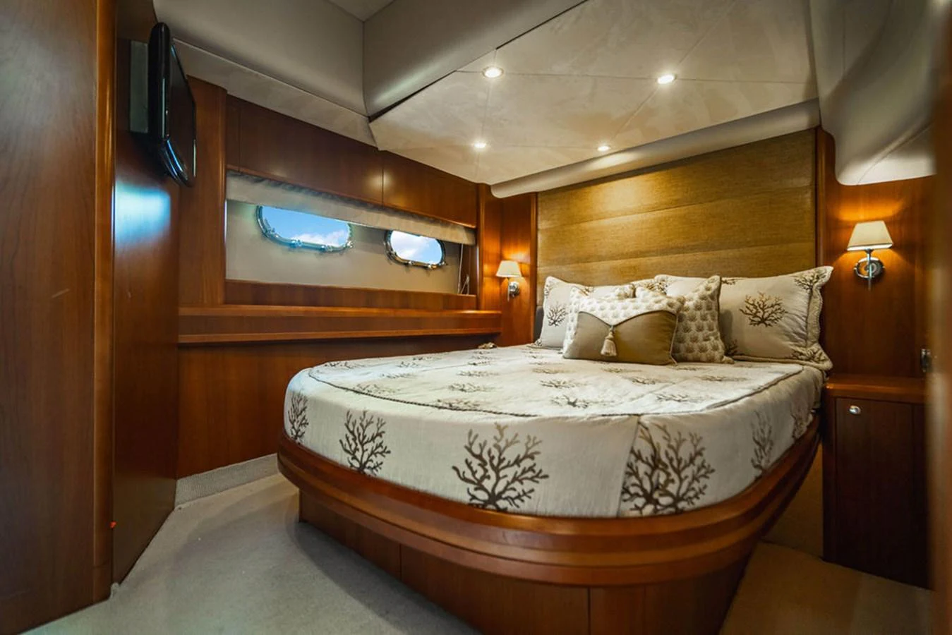 a bed with a white comforter aboard EMPIRE SUN Yacht for Sale