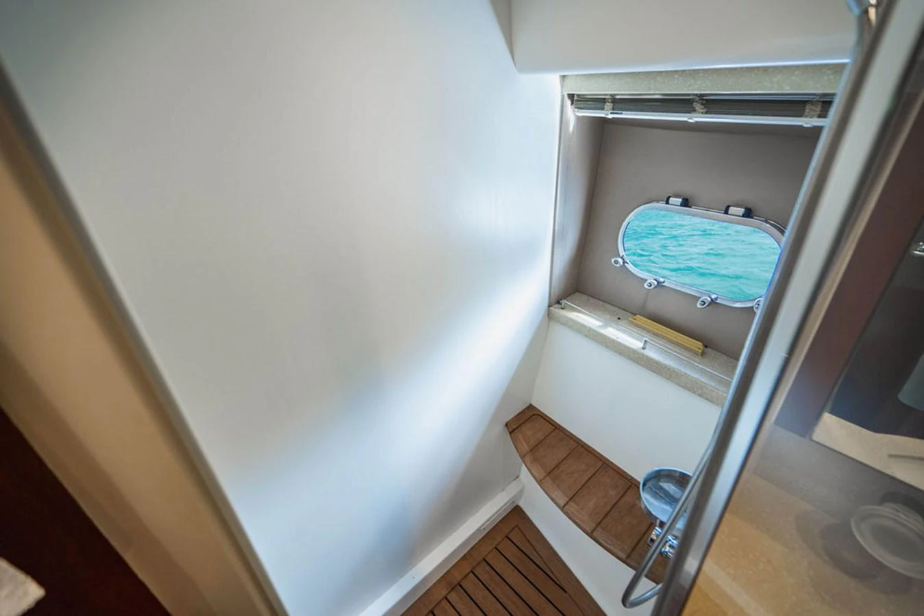 a toilet with a blue seat aboard EMPIRE SUN Yacht for Sale