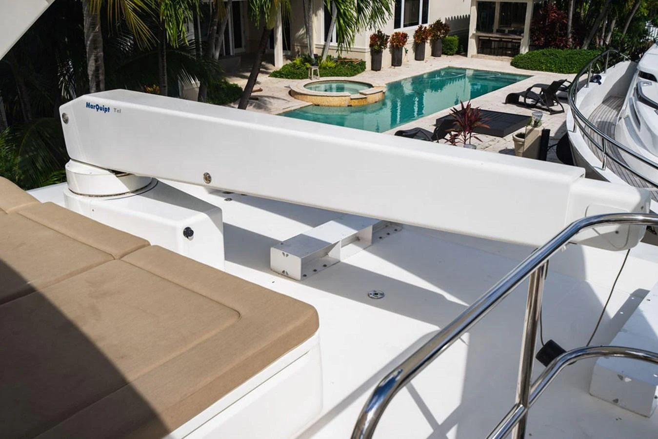 a white rectangular object on a white surface with a pool in the background aboard EMPIRE SUN Yacht for Sale