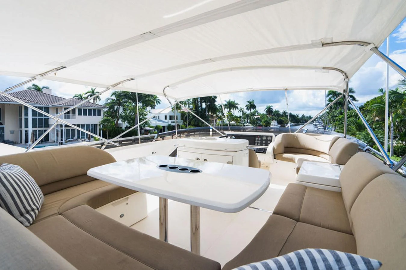 a table and a couch in a room with a large white tent aboard EMPIRE SUN Yacht for Sale