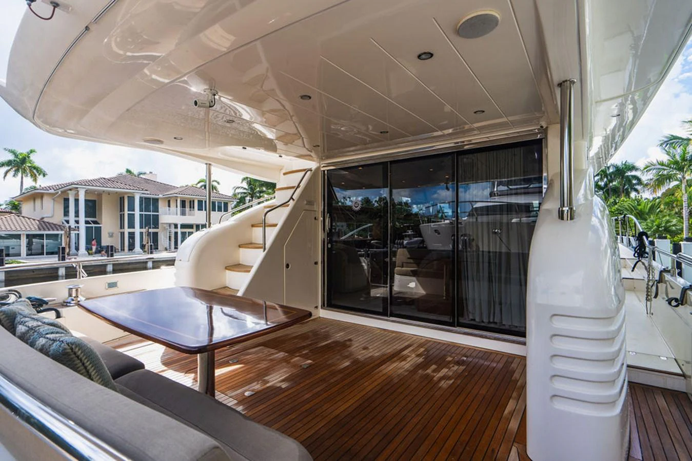 a large glass table on a deck aboard EMPIRE SUN Yacht for Sale