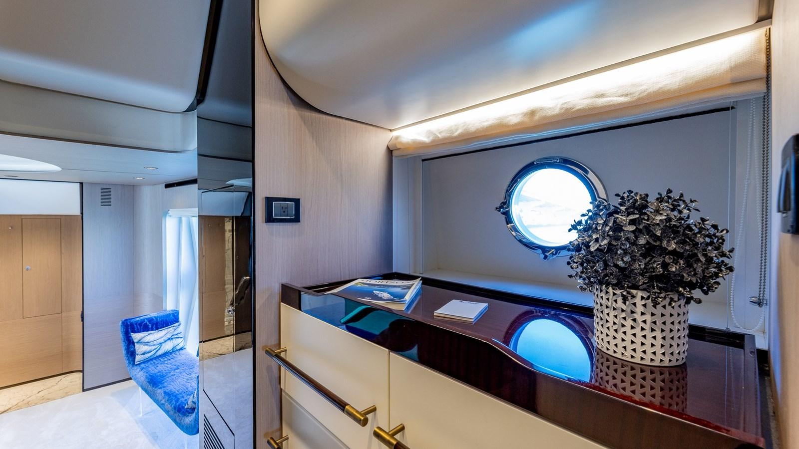 a room with a large mirror and a plant on the table aboard 4 PLAY Yacht for Sale