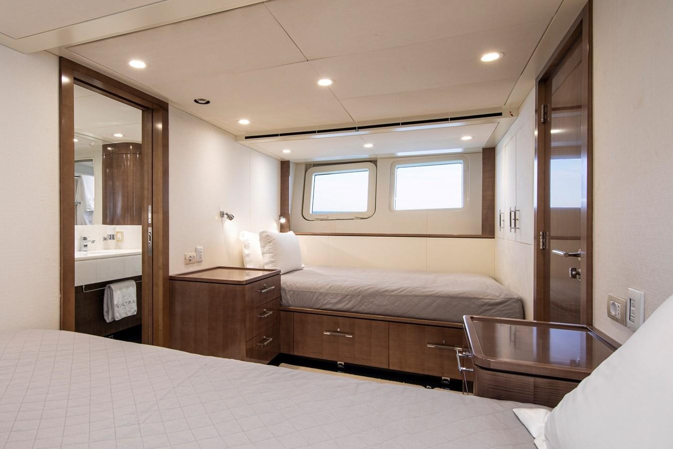 a hotel room with a bed and a mirror aboard VALYRA Yacht for Sale