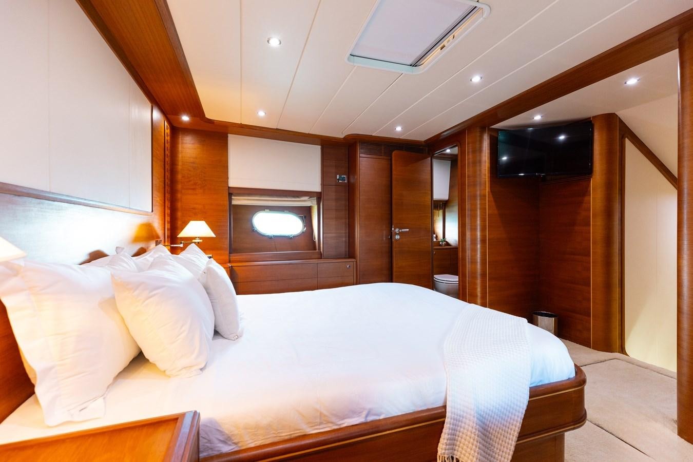 a bed with white sheets aboard ECLIPSE Yacht for Sale