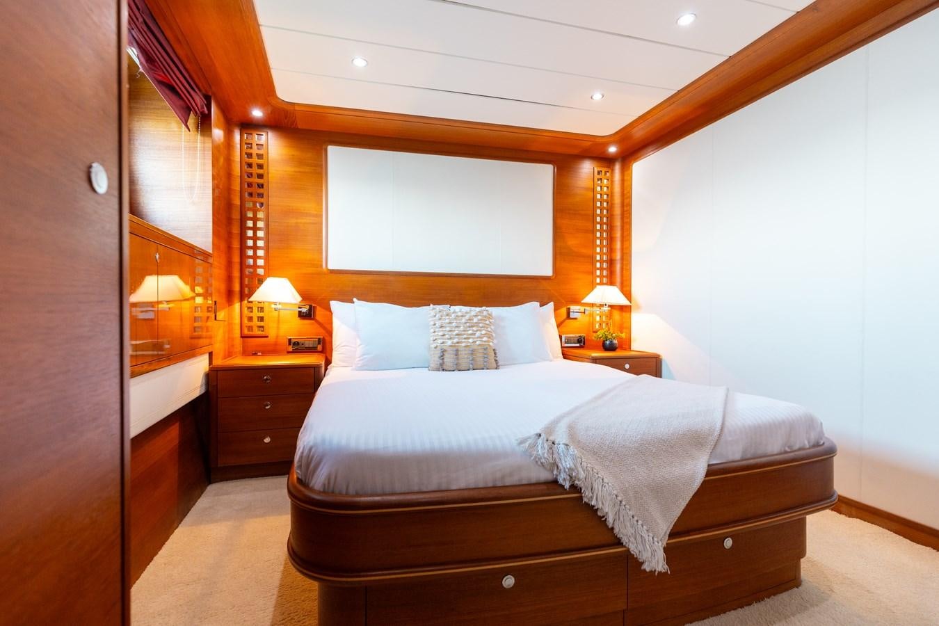 a bedroom with a bed and a desk aboard ECLIPSE Yacht for Sale