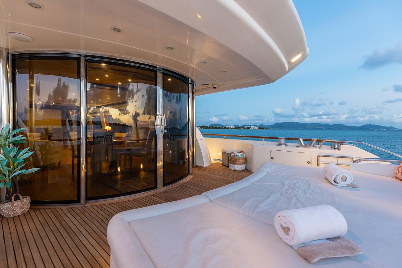 a bed on a deck overlooking the ocean aboard ECLIPSE Yacht for Sale