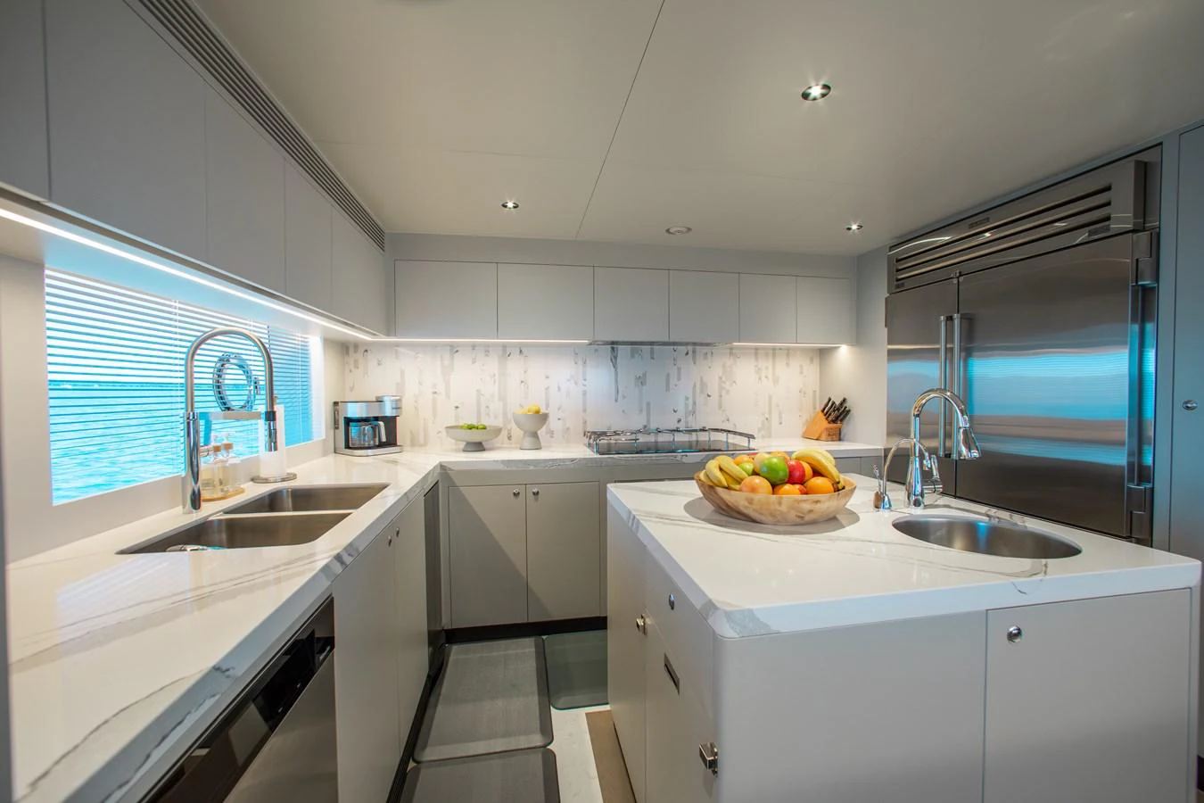 a kitchen with white cabinets aboard CROWNED EAGLE Yacht for Sale