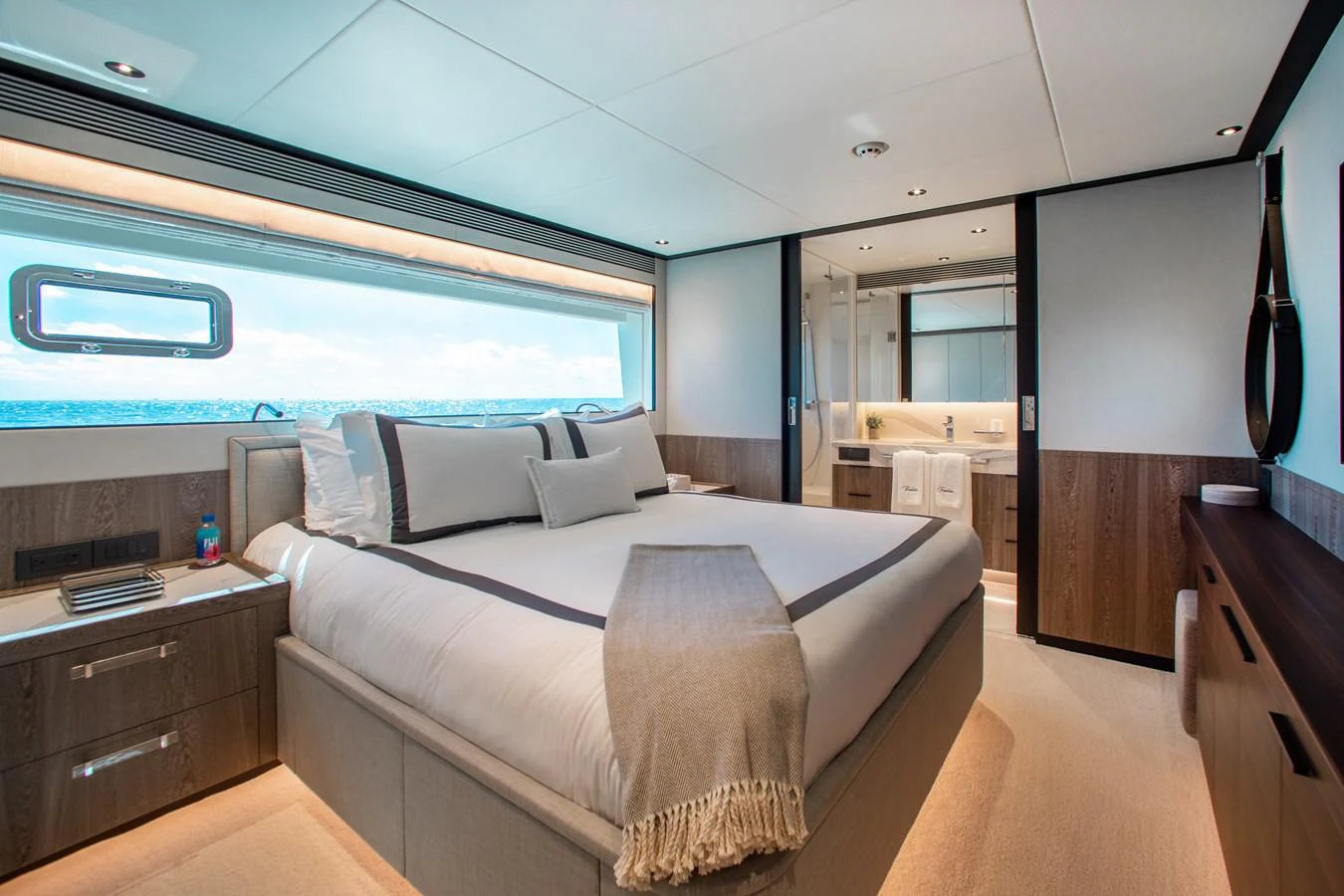 a room with a bed and a large window aboard CROWNED EAGLE Yacht for Sale