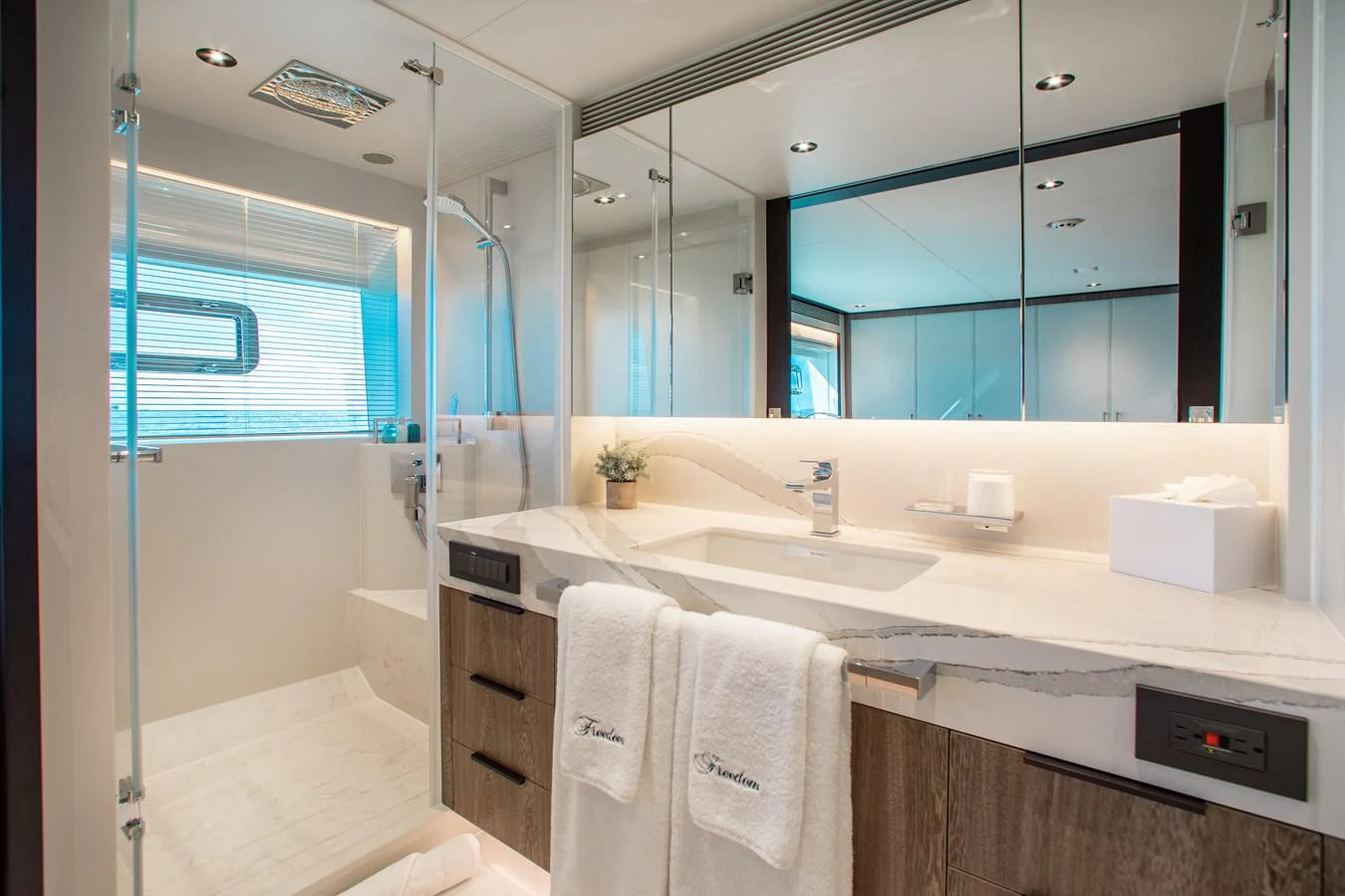 a bathroom with a large mirror aboard CROWNED EAGLE Yacht for Sale