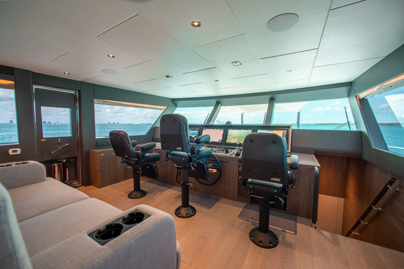 a room with chairs and a couch aboard CROWNED EAGLE Yacht for Sale