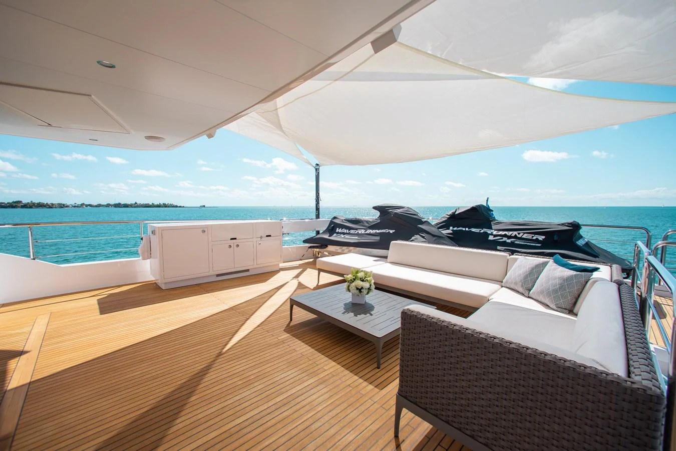 a room with a couch and a table and a large body of water aboard CROWNED EAGLE Yacht for Sale