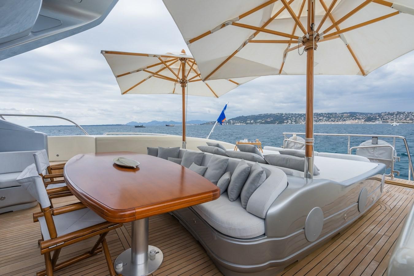 a table and chairs on a boat aboard MANGUSTA MAXI OPEN 108#23 - TECHNOMARINE - CAREFULLY USED Yacht for Sale