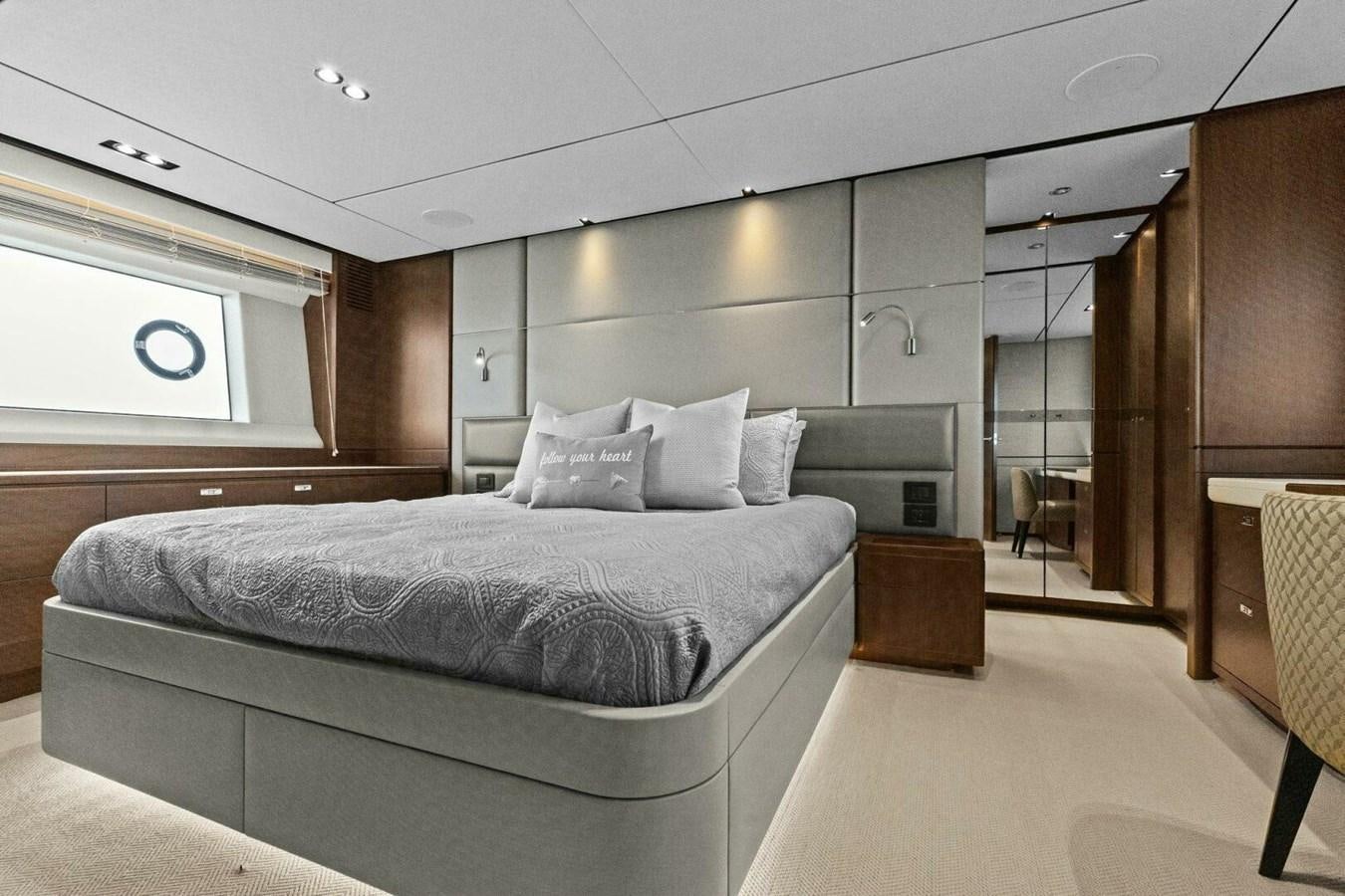 a bedroom with a bed and a desk aboard AMARULA SUN Yacht for Sale