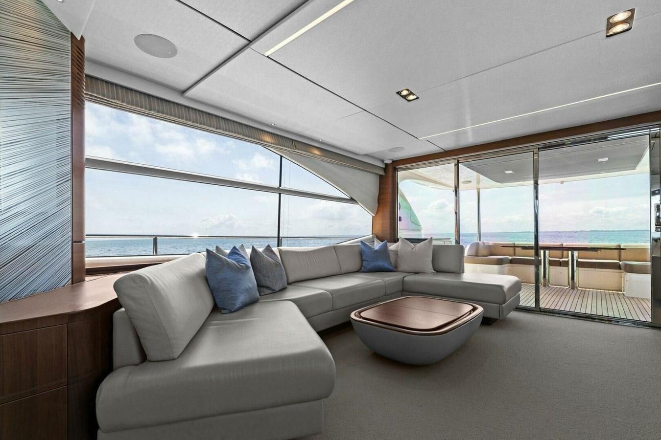 a living room with a couch and a table aboard AMARULA SUN Yacht for Sale