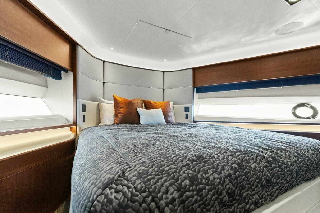 a bed with a blue blanket aboard AMARULA SUN Yacht for Sale