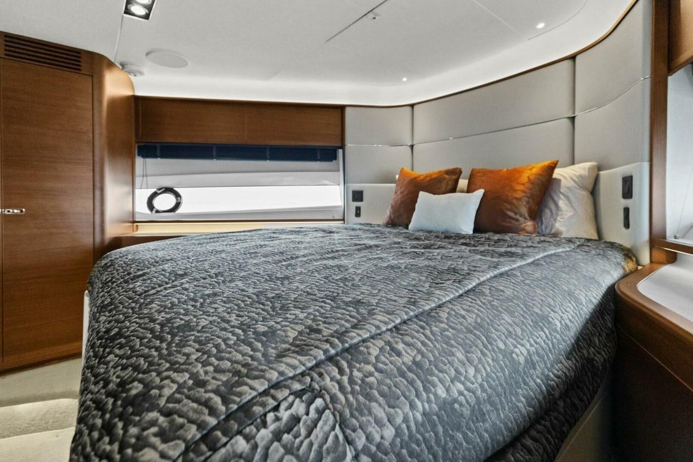 a bed with a blue comforter aboard AMARULA SUN Yacht for Sale
