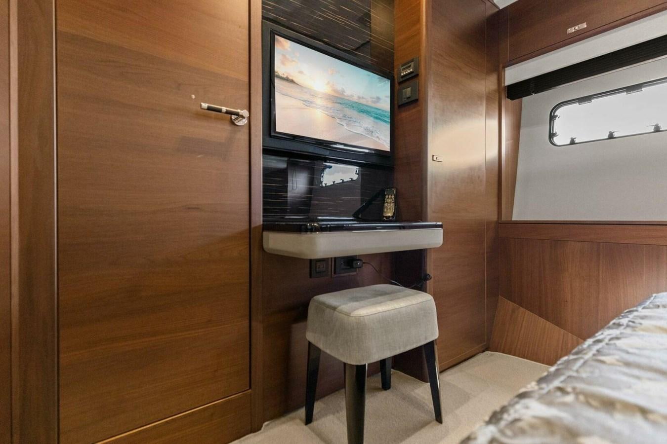 a small room with a small desk and a tv aboard AMARULA SUN Yacht for Sale
