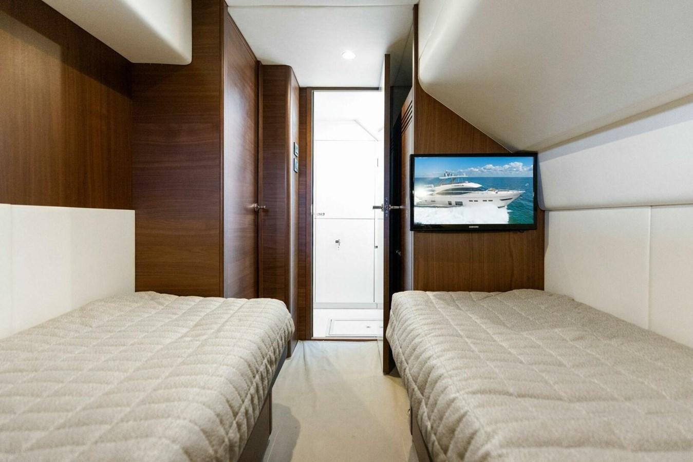 a room with a tv and a bed aboard AMARULA SUN Yacht for Sale