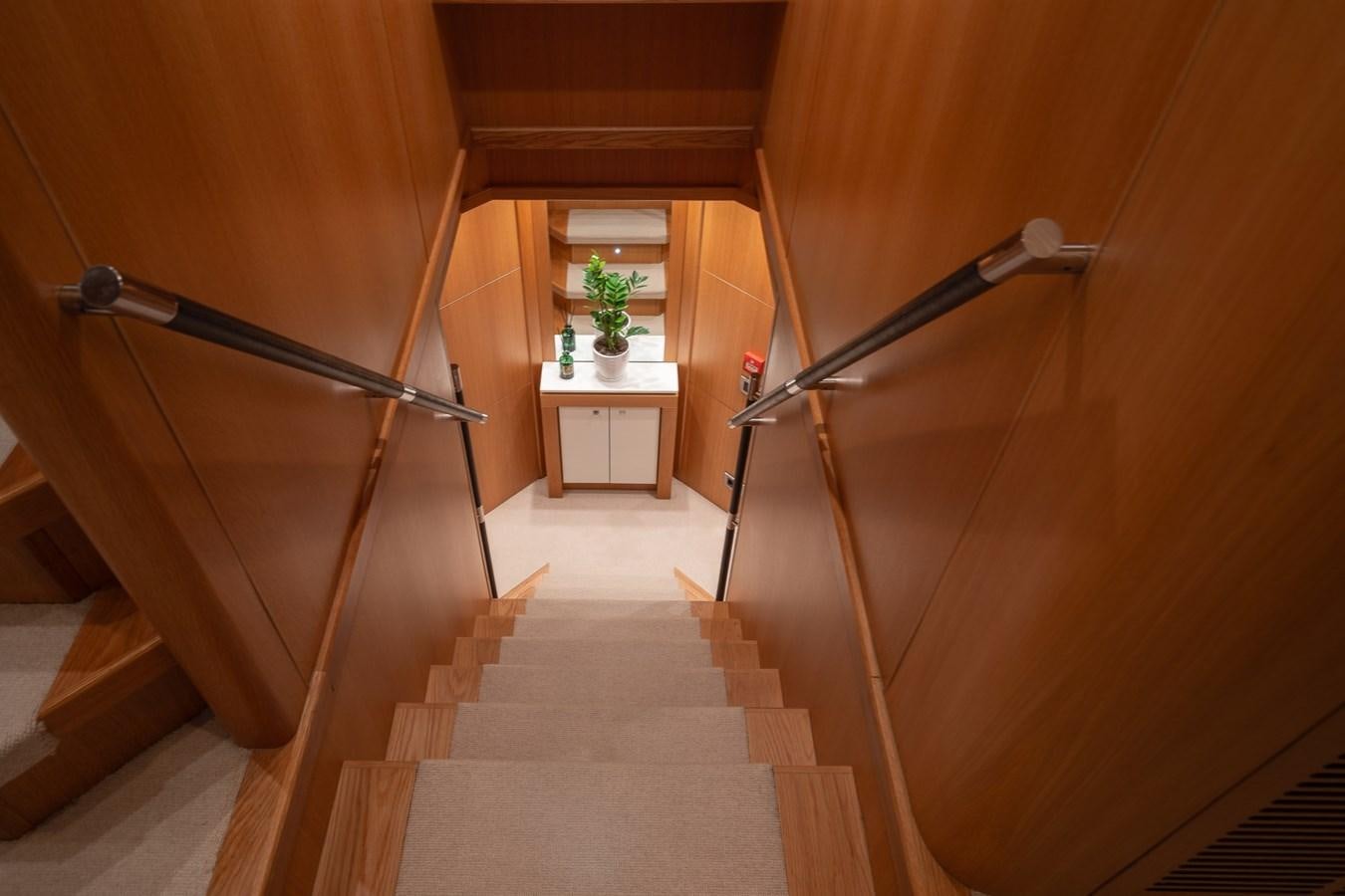 a wooden staircase with a railing aboard SUNSEEKER PREDATOR 115 Yacht for Sale