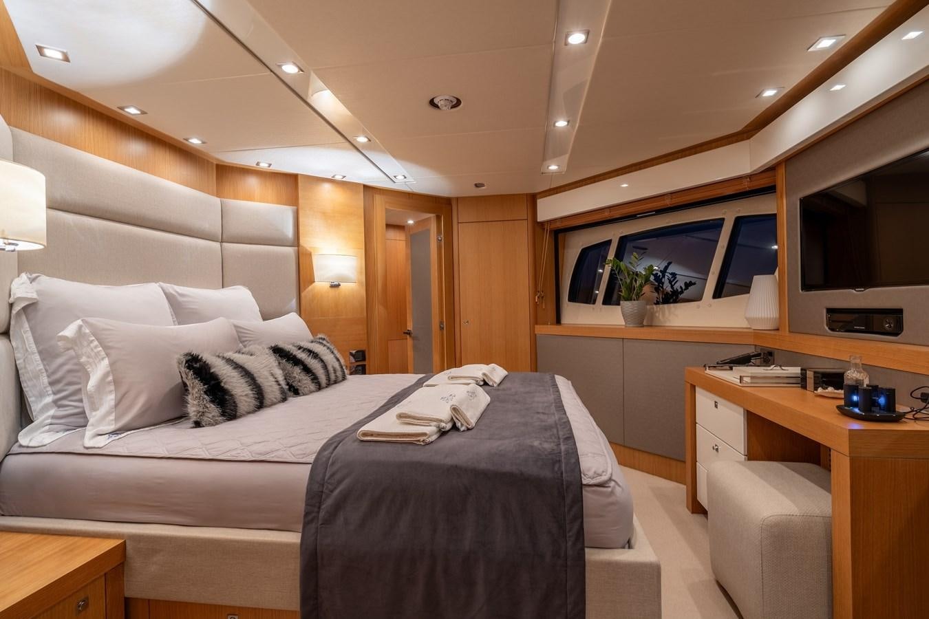 a bedroom with a bed and a desk aboard SUNSEEKER PREDATOR 115 Yacht for Sale