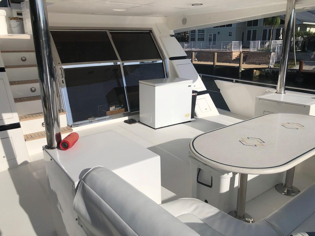a room with a table and chairs aboard MADNESS Yacht for Sale