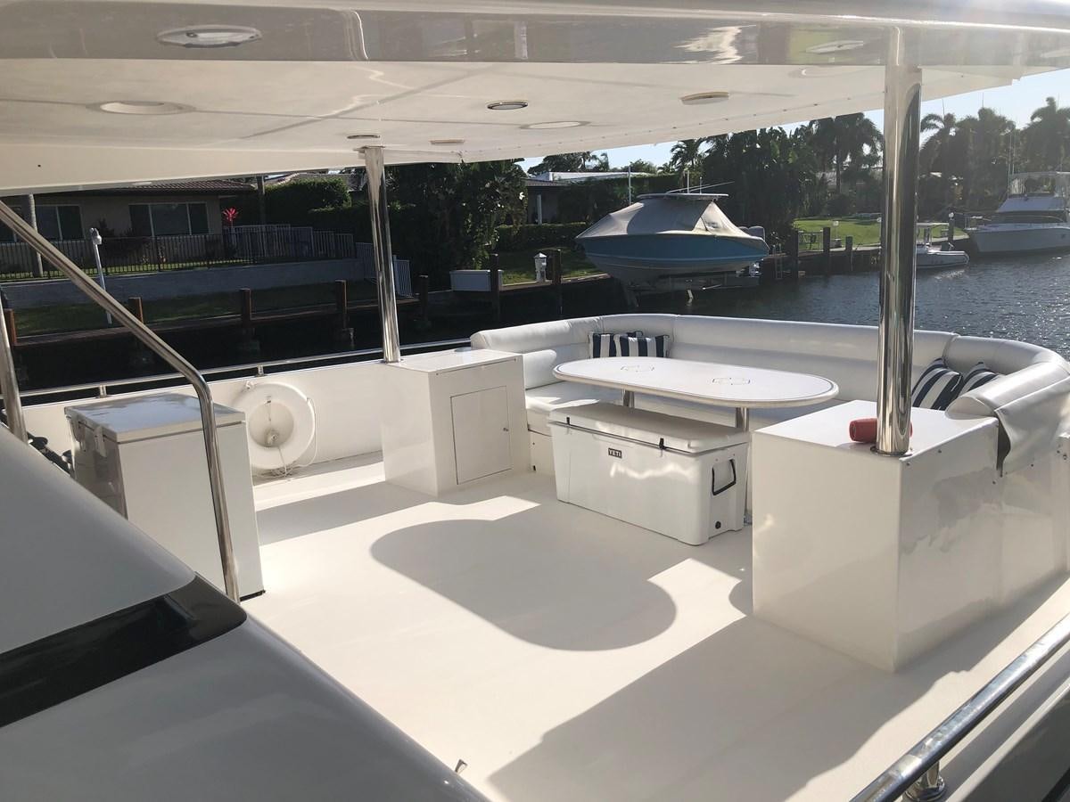 a room with a pool table and chairs aboard MADNESS Yacht for Sale