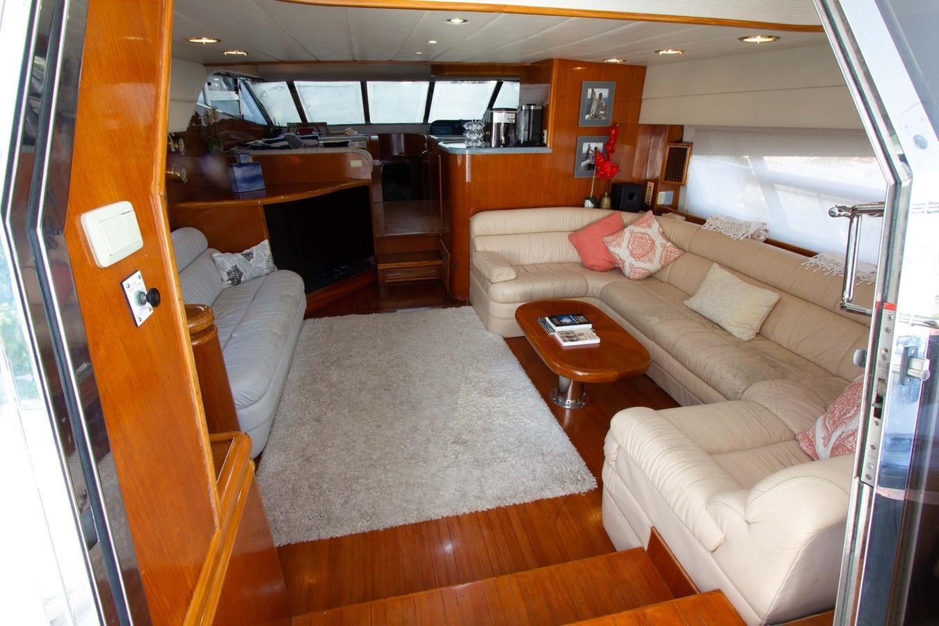 a living room with a couch and a coffee table aboard MADNESS Yacht for Sale