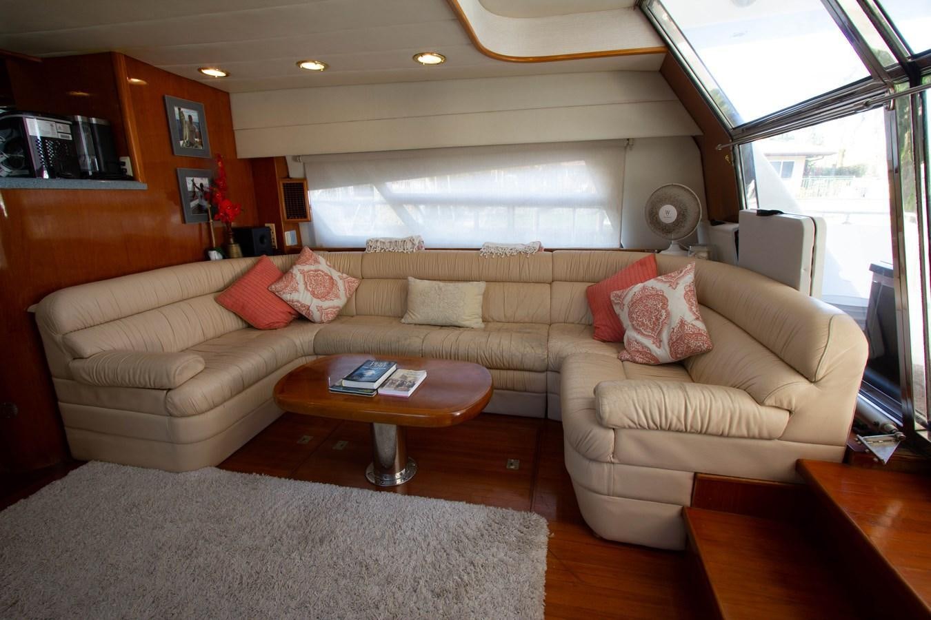 a living room with a couch and a coffee table aboard MADNESS Yacht for Sale