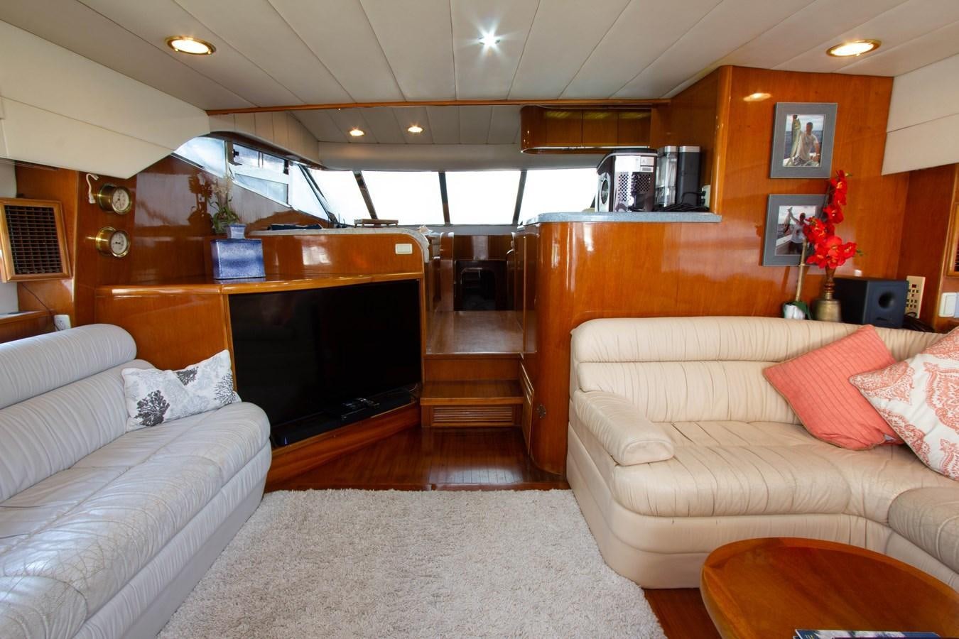 a living room with a couch and a television aboard MADNESS Yacht for Sale