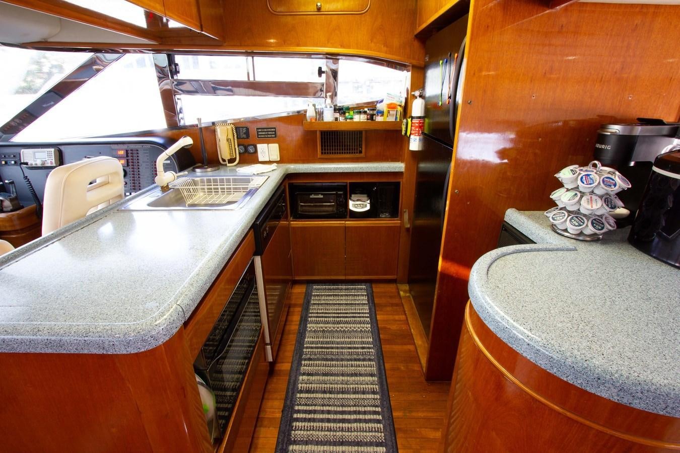 a kitchen with a sink and a table aboard MADNESS Yacht for Sale