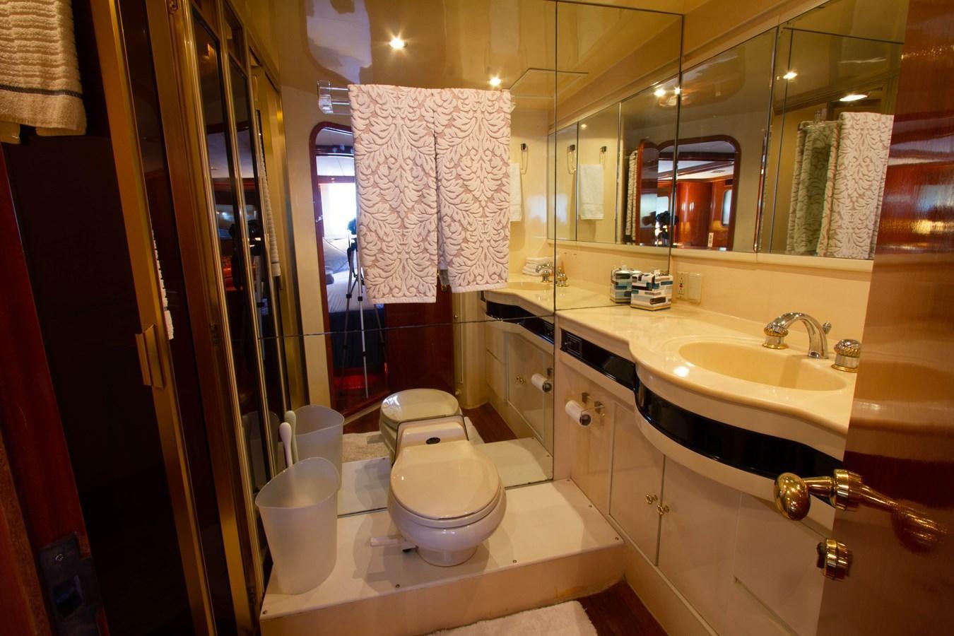 a bathroom with a sink toilet and a mirror aboard MADNESS Yacht for Sale