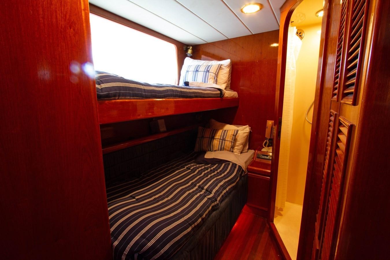 a bed in a room aboard MADNESS Yacht for Sale