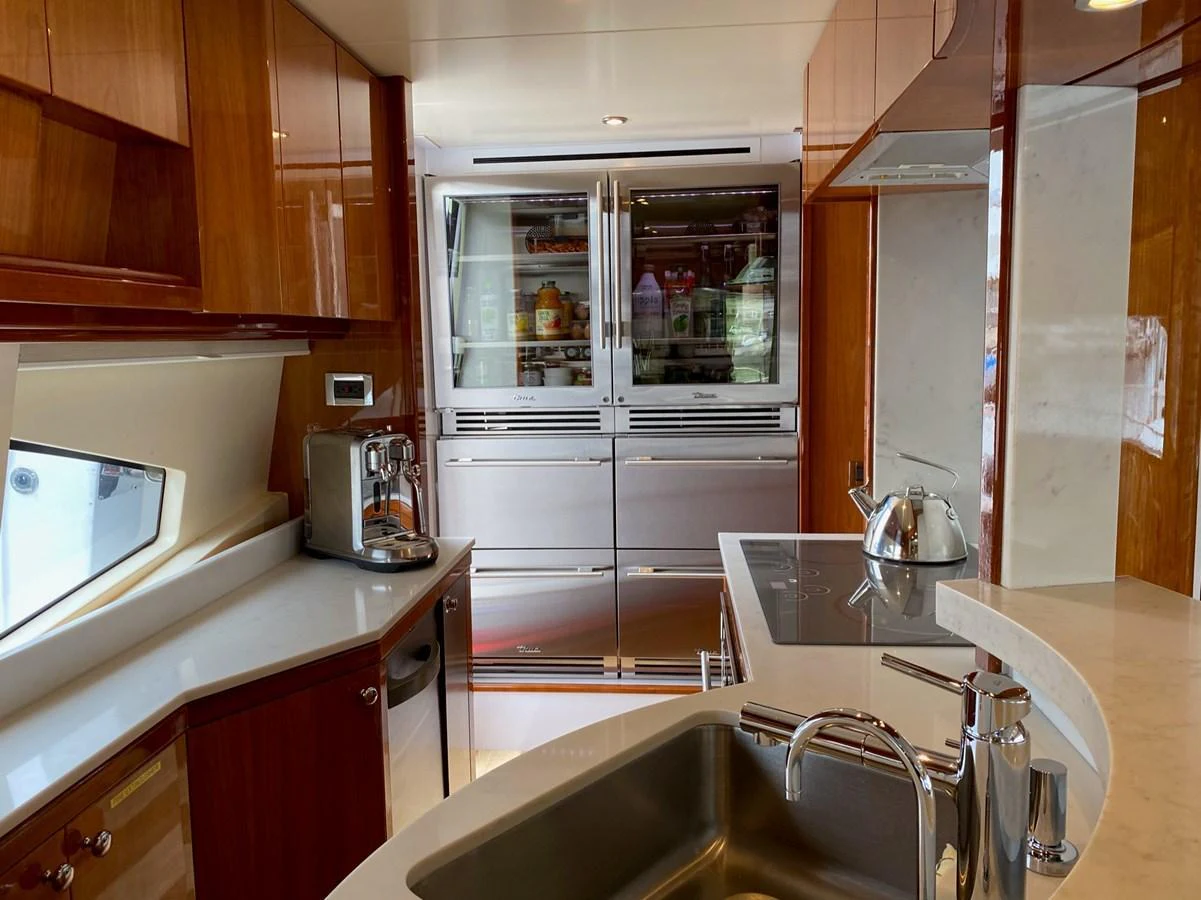 a kitchen with a stainless steel refrigerator aboard AZIMUT 100/32 Yacht for Sale