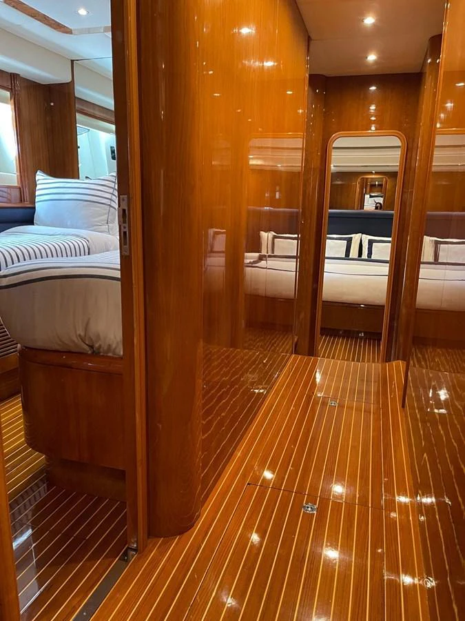 a room with a wood floor and a bed aboard AZIMUT 100/32 Yacht for Sale