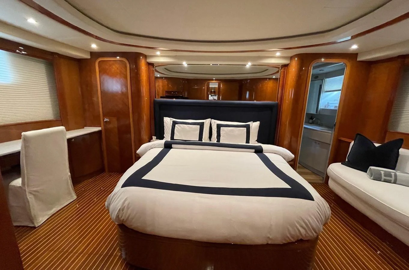 a room with a bed and chairs aboard AZIMUT 100/32 Yacht for Sale