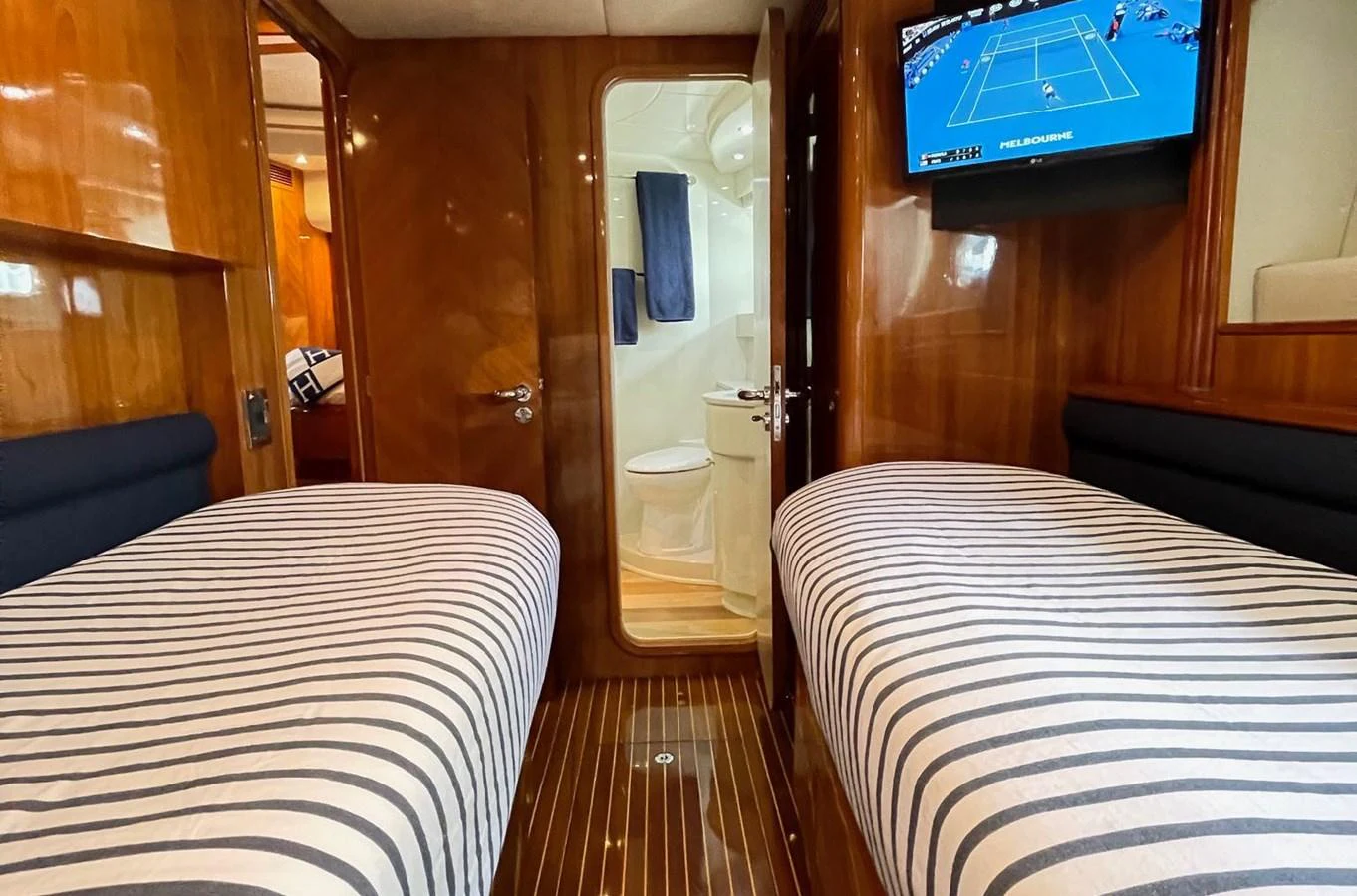 a room with a bed and a tv on the wall aboard AZIMUT 100/32 Yacht for Sale