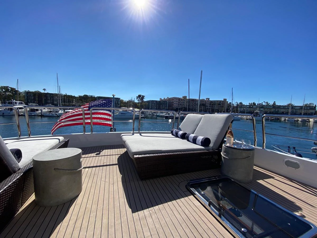 a deck with a chair and a table on it aboard AZIMUT 100/32 Yacht for Sale