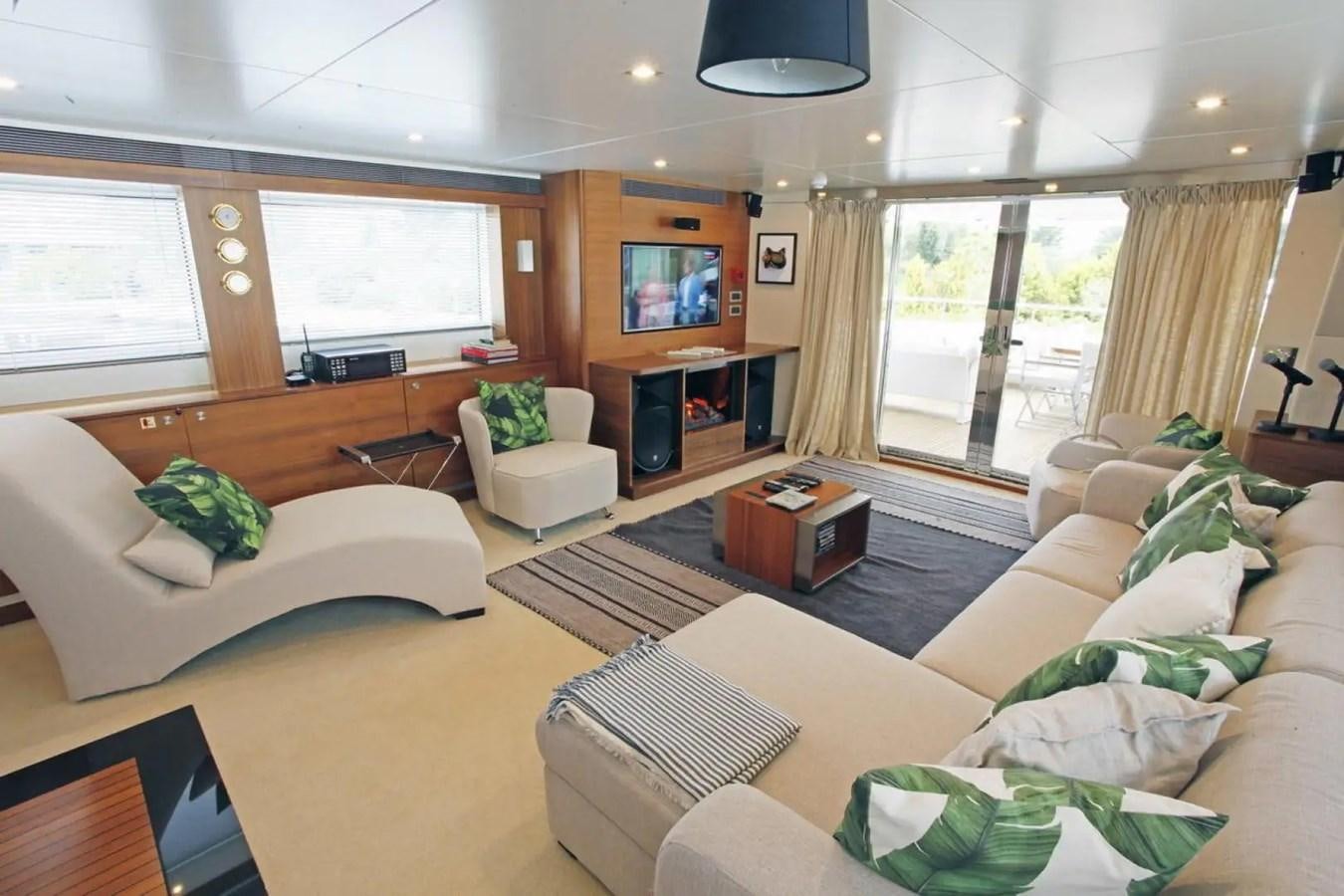 a living room with a fireplace aboard DELETE MR MOUSE Yacht for Sale