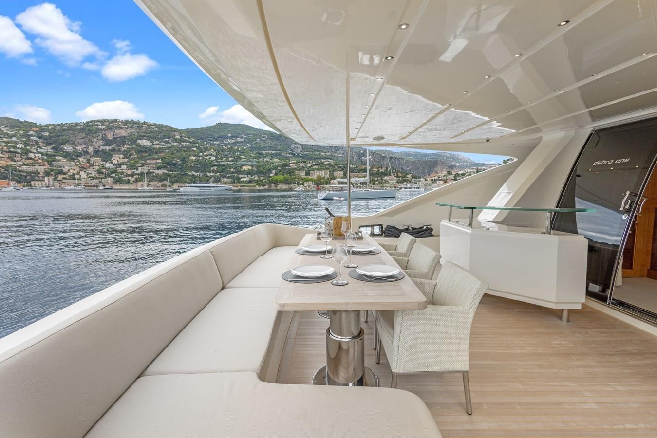 a room with a table and chairs aboard DEBRA ONE Yacht for Sale