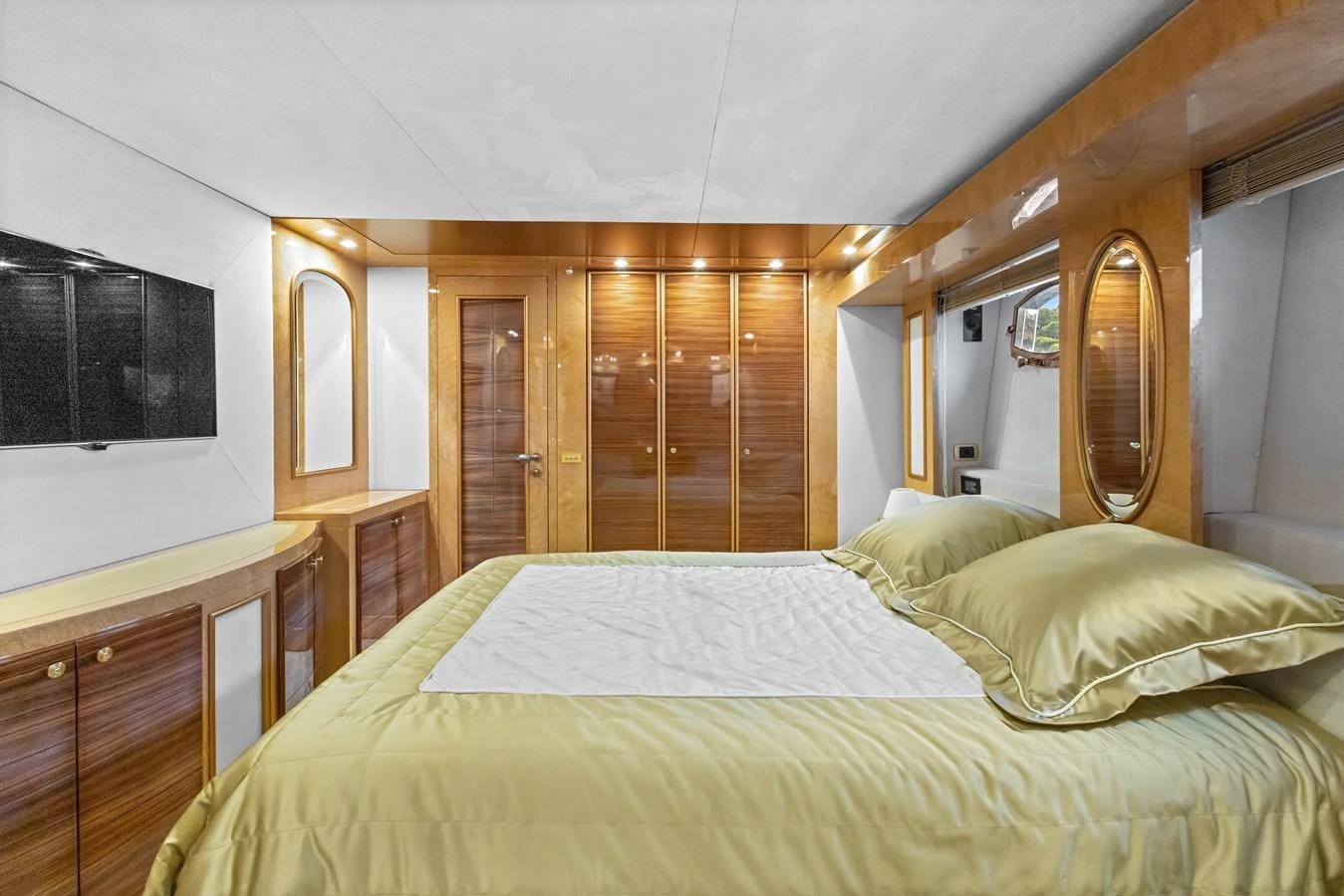 a bedroom with a bed and a mirror aboard DEBRA ONE Yacht for Sale