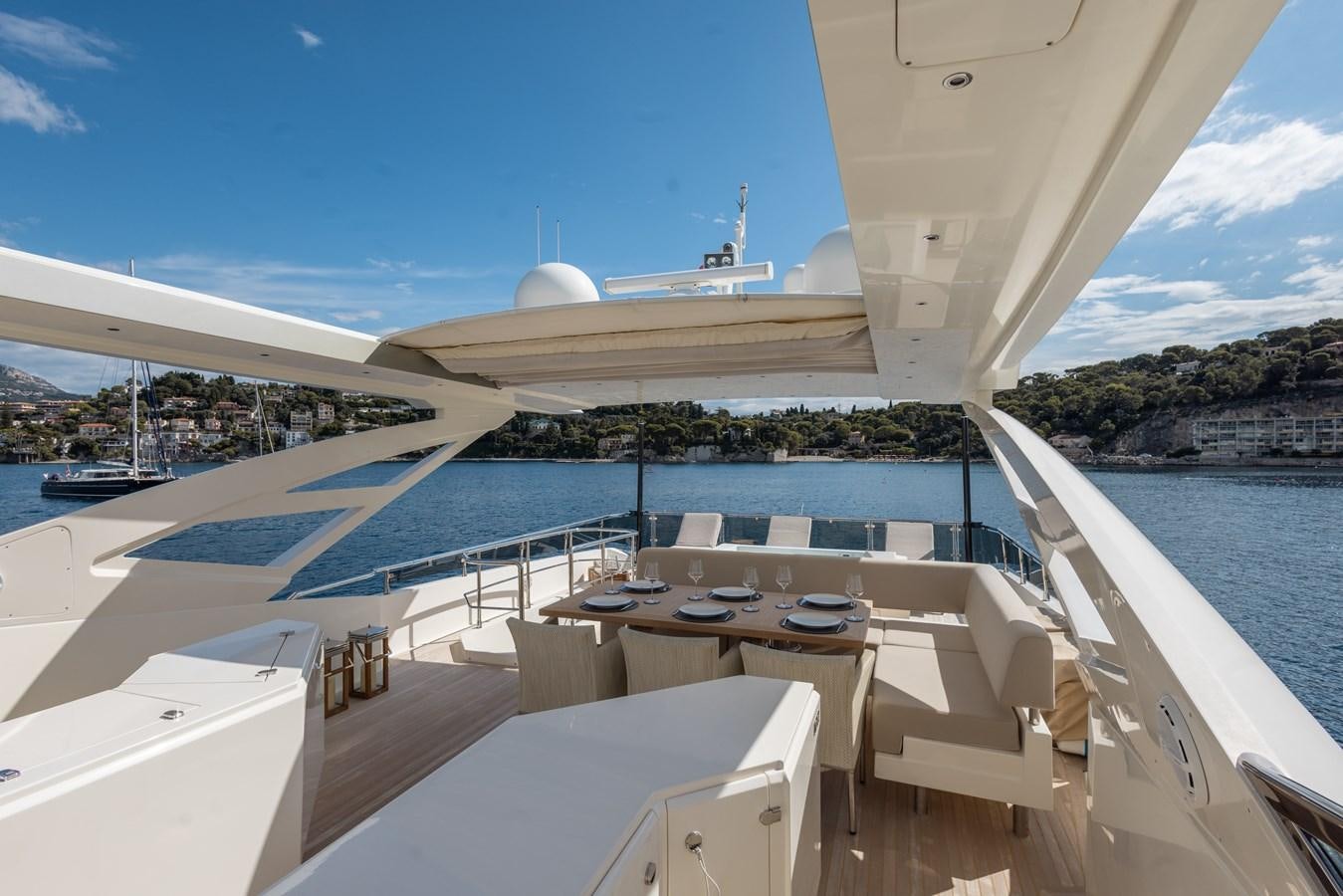 a deck with a view of a ship and a large building in the background aboard DEBRA ONE Yacht for Sale