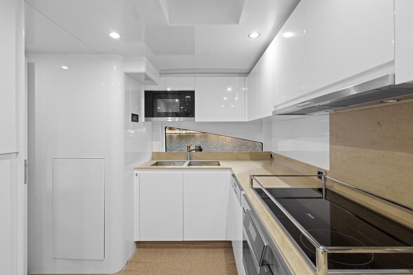 a kitchen with white cabinets aboard DEBRA ONE Yacht for Sale