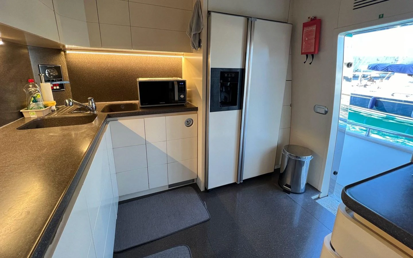 a kitchen with a sliding glass door aboard WILLFUL Yacht for Sale