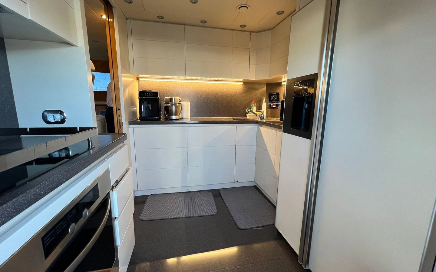 a kitchen with white cabinets aboard WILLFUL Yacht for Sale