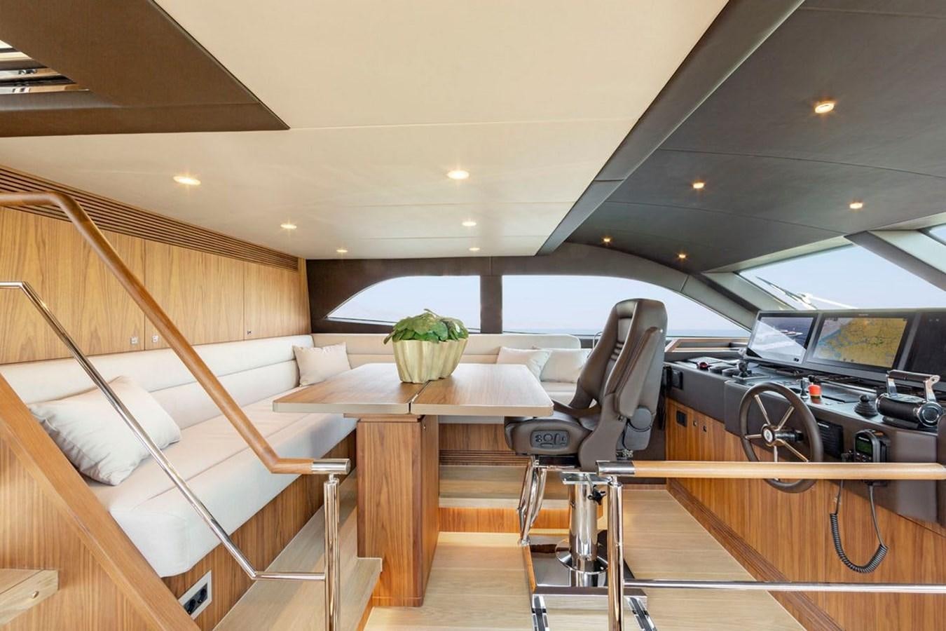 a room with a table and chairs aboard HELGA Yacht for Sale