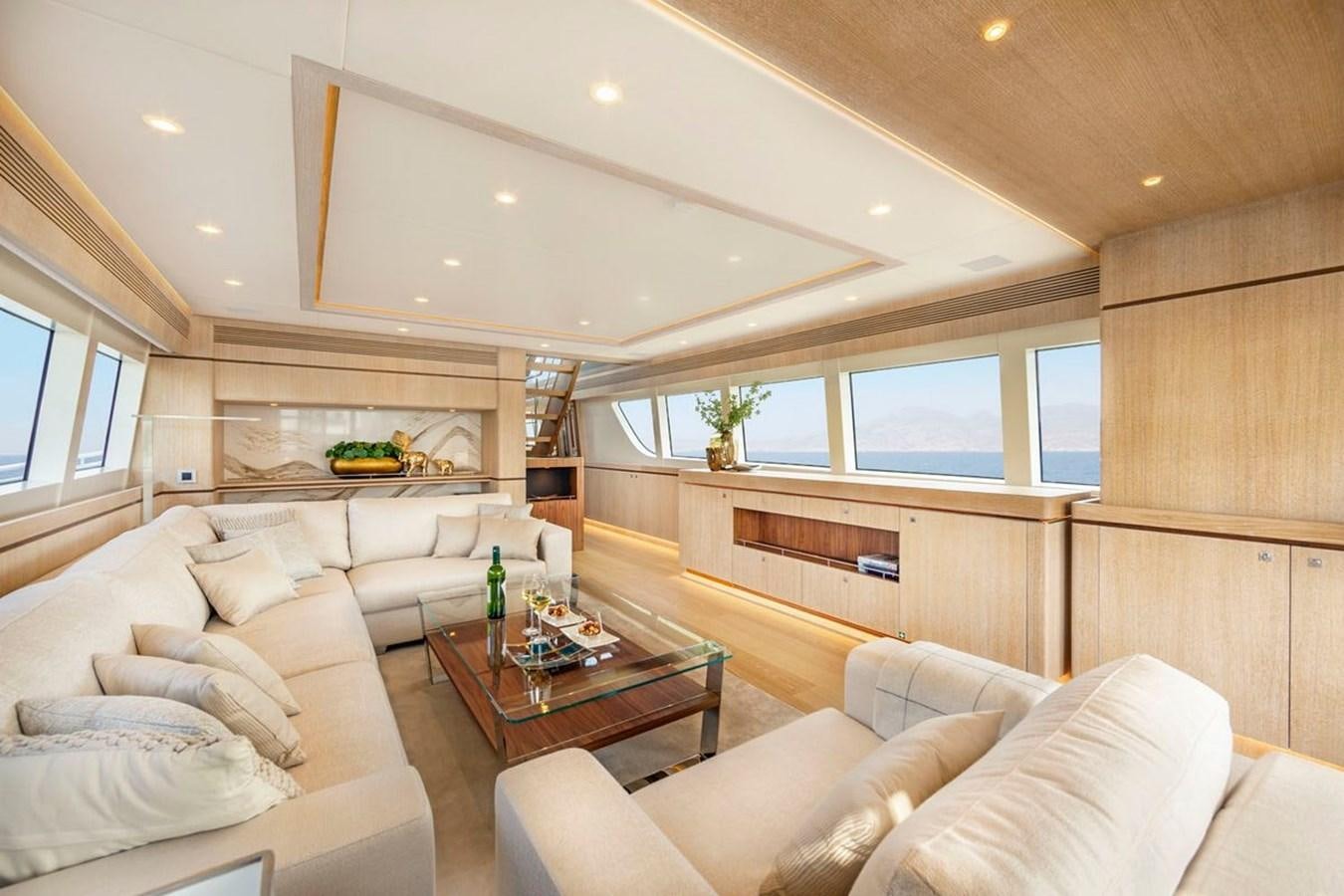 a living room with a table aboard HELGA Yacht for Sale