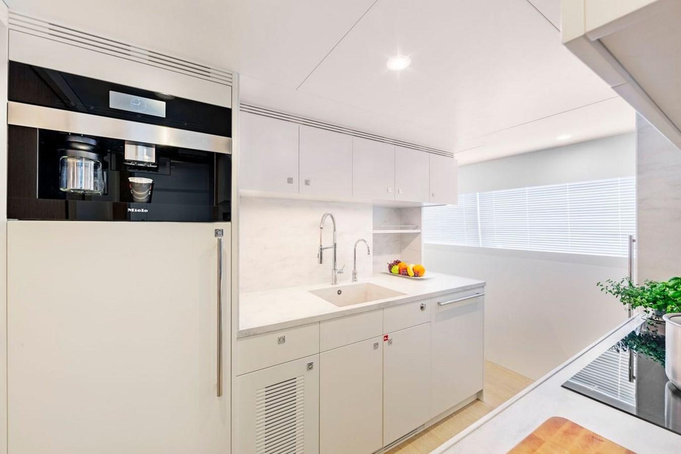 a kitchen with white cabinets aboard HELGA Yacht for Sale