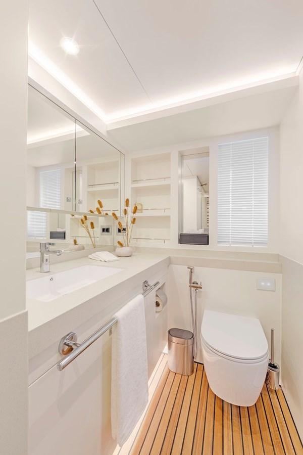 a bathroom with a sink toilet and a mirror aboard HELGA Yacht for Sale