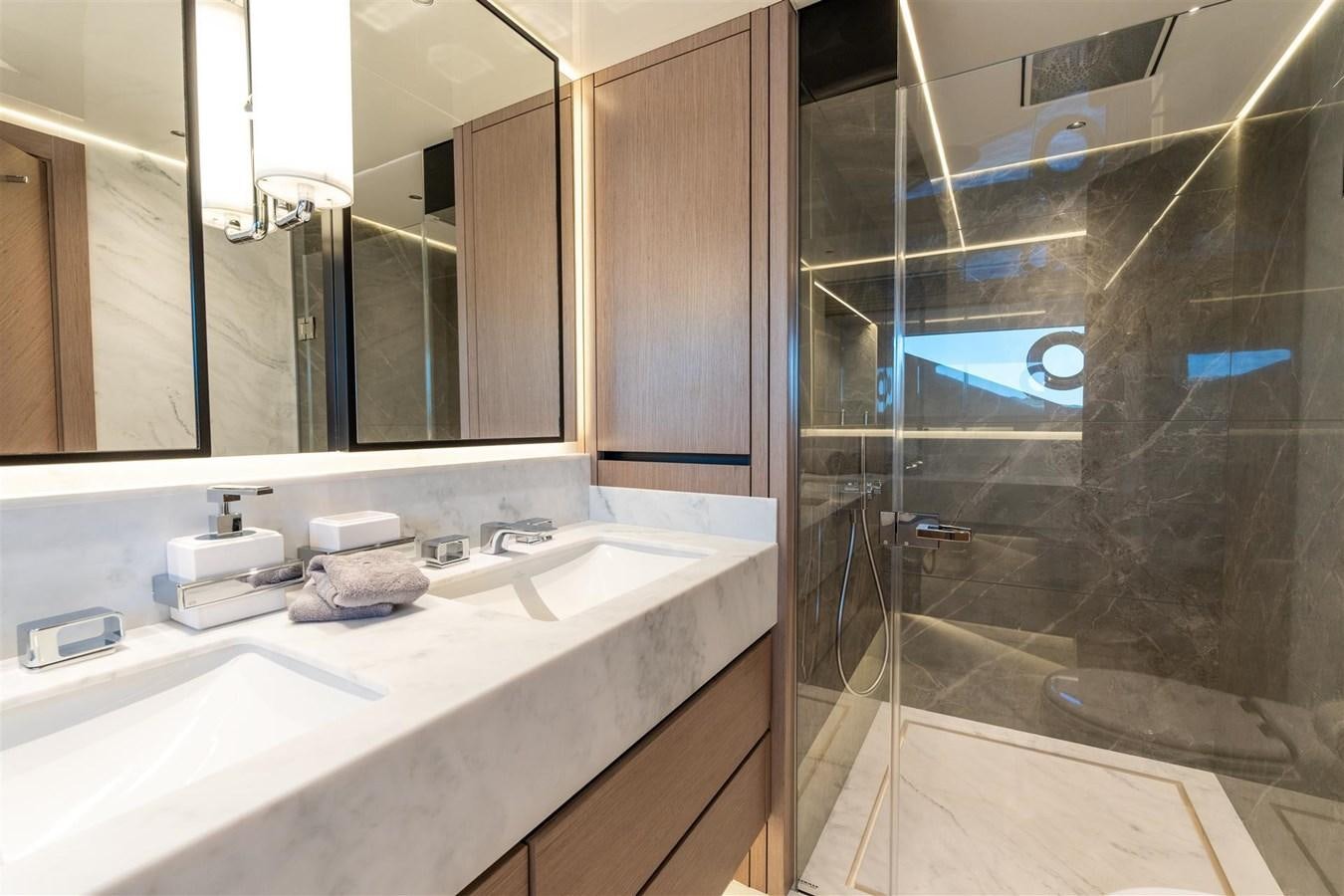 a bathroom with a glass shower aboard OCEAN 182 Yacht for Sale