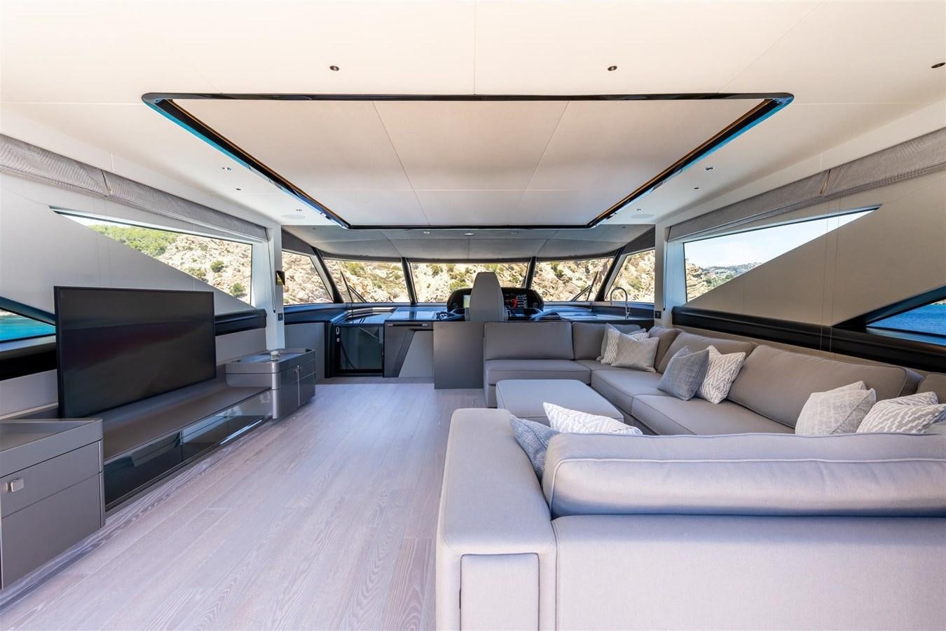 a room with a couch and a television aboard OCEAN 182 Yacht for Sale